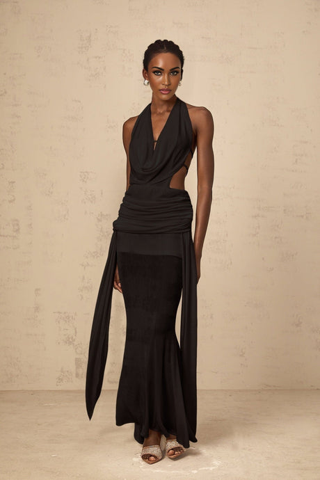 A black halterneck maxi dress with a backless design featuring a long flowing skirt and sleeveless style