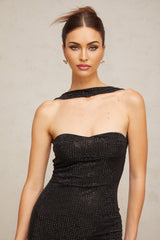 A black halterneck mini dress with rhinestone embellishments worn by a model standing against a plain background