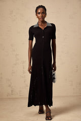 A black knit midi dress with studded embellishments featuring a fitted silhouette and long sleeves named Laetitia
