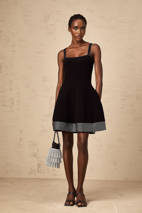 A black knit mini dress with flared skirt and studded details named Eliane