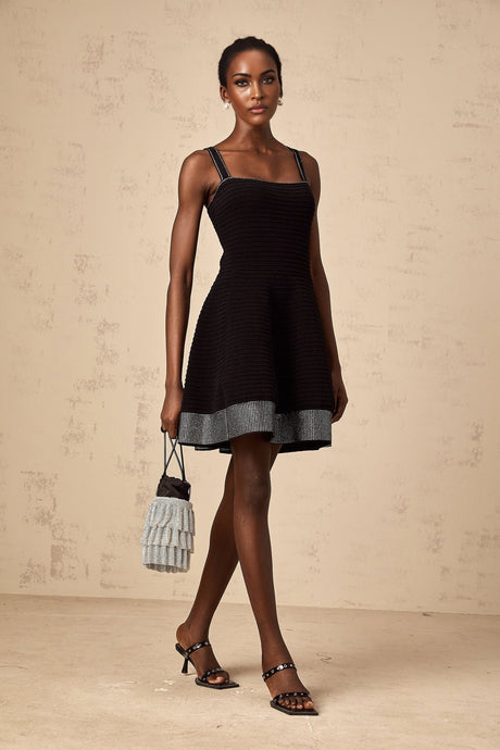 A black knit mini dress with flared skirt and studded details named Eliane