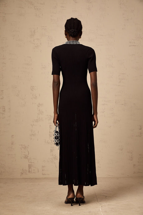 A black knitted midi dress with studded embellishments named Laetitia featuring a fitted silhouette and long sleeves