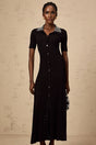 A black knitted midi dress with studded embellishments named Laetitia featuring a fitted silhouette and long sleeves