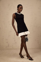 A black knitted mini dress with ruffled details and faux pearl embellishments named Elodie