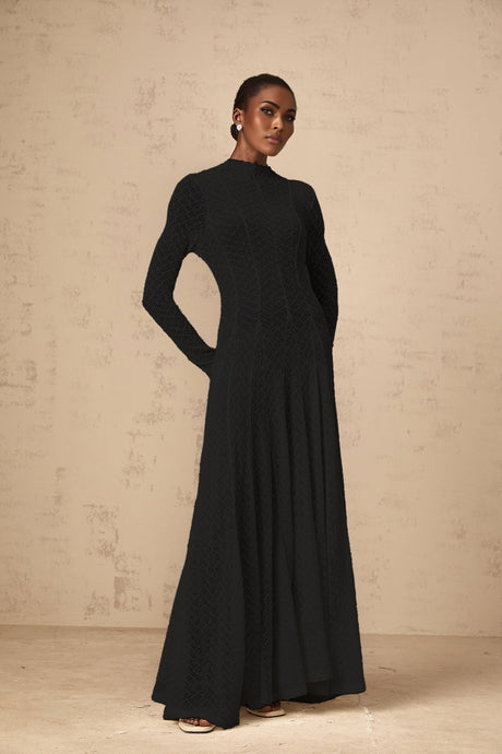 A black lace maxi dress with a wavy pattern design named Athena featuring a full length skirt and delicate lace detailing throughout