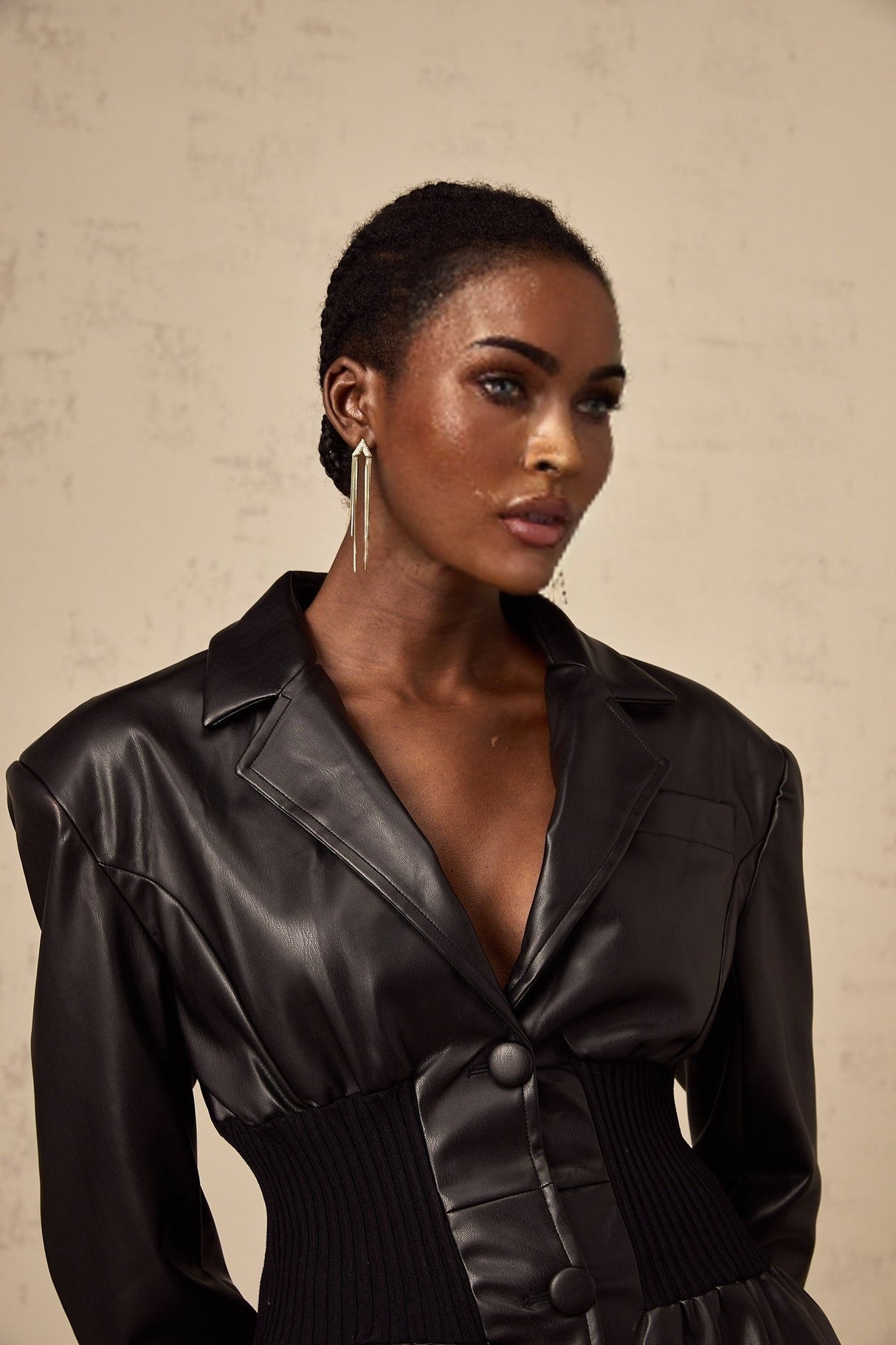 A black leather jacket with panelled design details featuring the Mirella brand