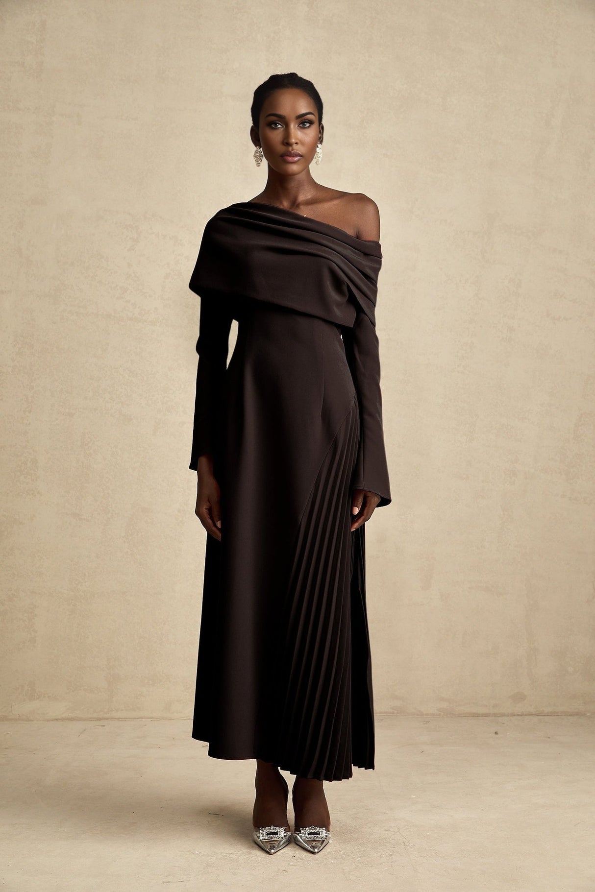 A black long maxi dress with a high slit and pleated design suitable for Valentines Day occasion