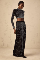 A black matching set consisting of a mesh top and skirt adorned with rhinestones featuring a shimmering and elegant design