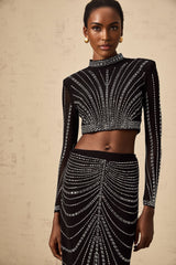 A black matching set featuring a mesh top and skirt adorned with rhinestone embellishments