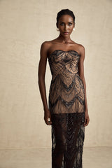 A black maxi dress with a sequinned corset bodice and sheer mesh skirt featuring long sleeves and a floor length silhouette