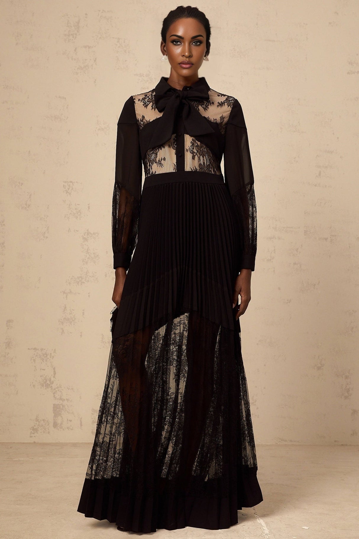 A black maxi dress with pleated skirt and floral lace panels named Segolene