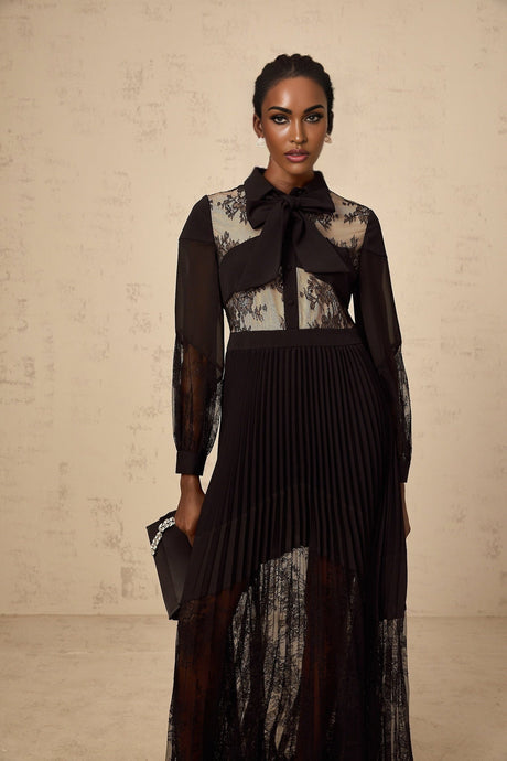 A black maxi dress with pleats and floral lace panels named Segolene