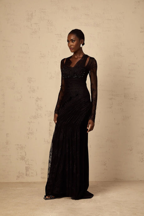 A black mermaid style maxi dress with floral lace pattern featuring a fitted bodice and flared skirt