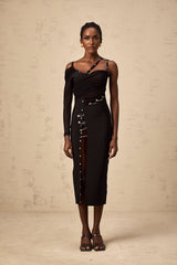 A black midi dress with an asymmetric design and cutout details worn by a model named Louise