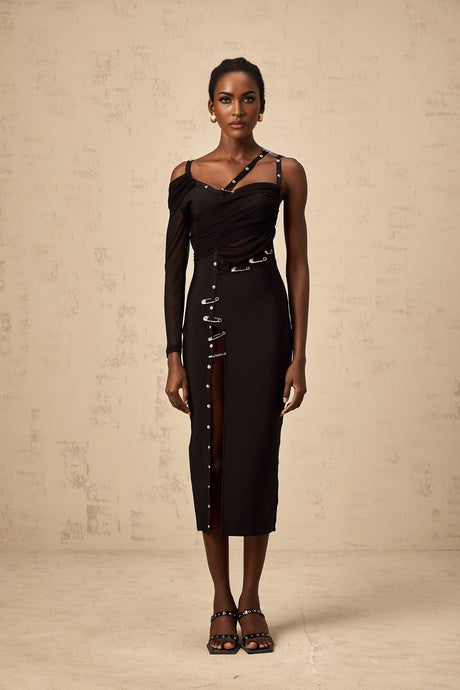 A black midi dress with an asymmetric design and cutout details worn by a model named Louise