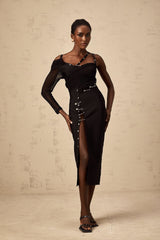 A black midi dress with an asymmetric hemline and cutout details worn by a model named Louise
