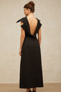 A black midi dress with an open back and deconstructed design featuring a sleek silhouette and elegant style