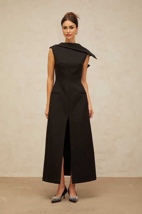 A black midi dress with an open back and deconstructed design featuring Leonore style