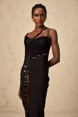A black midi dress with asymmetric design and cut out details featuring a form fitting silhouette and stylish modern look