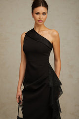A black midi dress with asymmetric hem featuring lace panels and a sleek silhouette