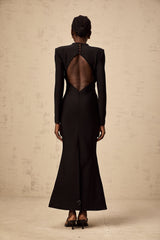 A black midi dress with cutout details featuring a sun motif pattern and ruched fabric Astrid style with a formfitting silhouette