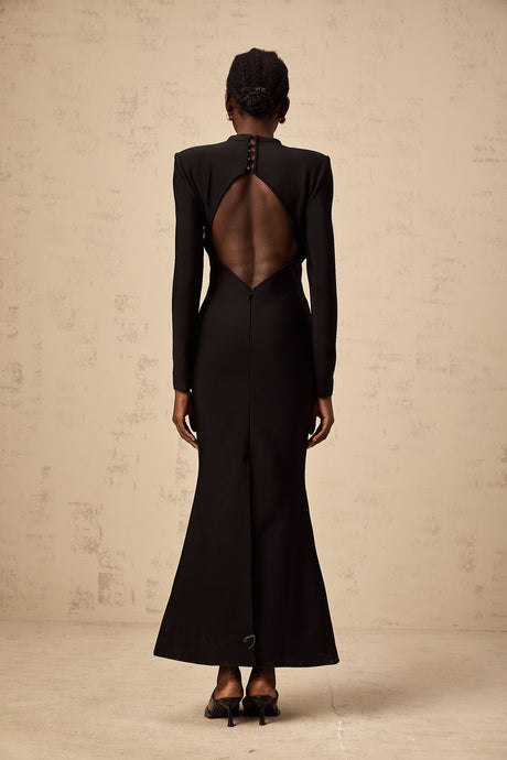 A black midi dress with cutout details featuring a sun motif pattern and ruched fabric Astrid style with a formfitting silhouette