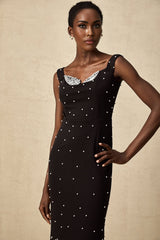 A black midi dress with faux pearl embellishments called Apolline