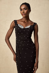 A black midi dress with faux pearl embellishments named Apolline