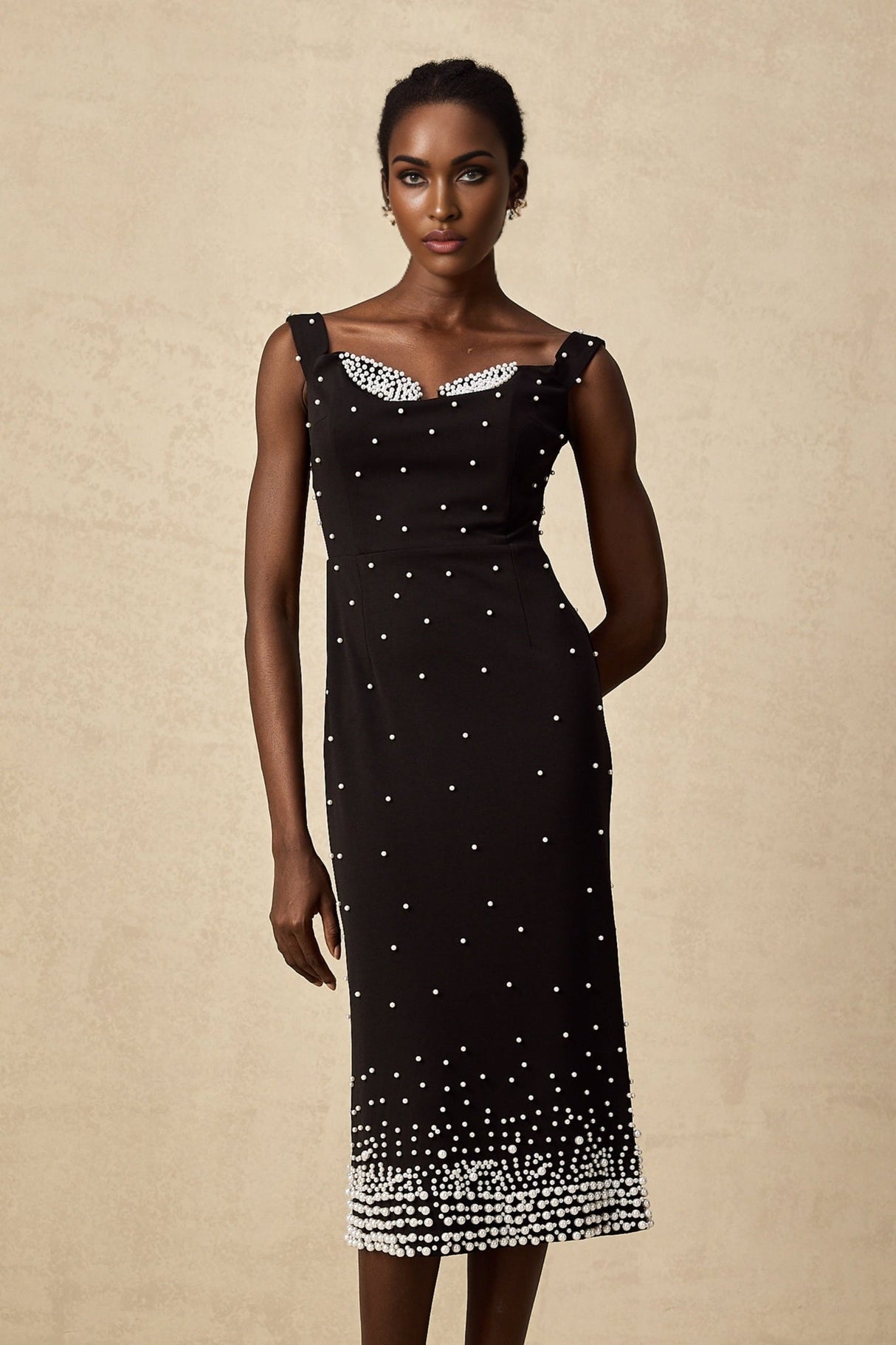 A black midi dress with faux pearl embellishments named Apolline
