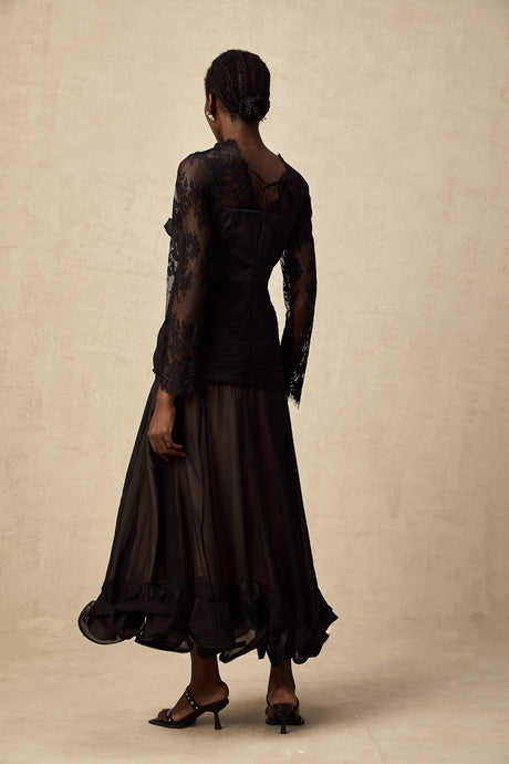 A black midi dress with floral lace panels and sheer details named Amelie