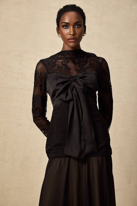 A black midi dress with floral lace panels named Amelie featuring a fitted silhouette and delicate floral patterns throughout the fabric