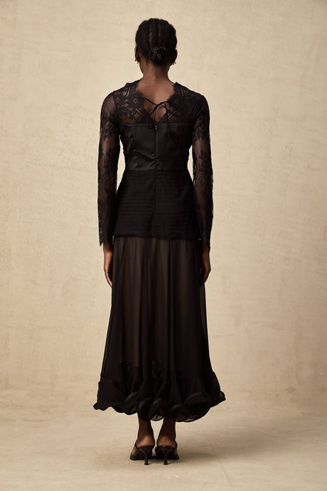 A black midi dress with floral lace panels named Amelie featuring a fitted silhouette and delicate floral patterns throughout