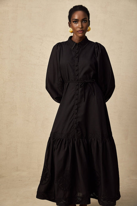 A black midi dress with lace embroidery detail featuring a fitted silhouette and delicate floral patterns