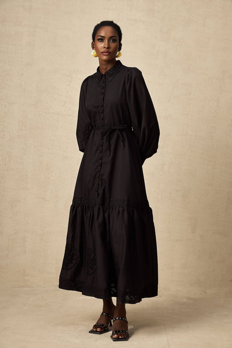A black midi dress with lace embroidery details in an Arcadia style