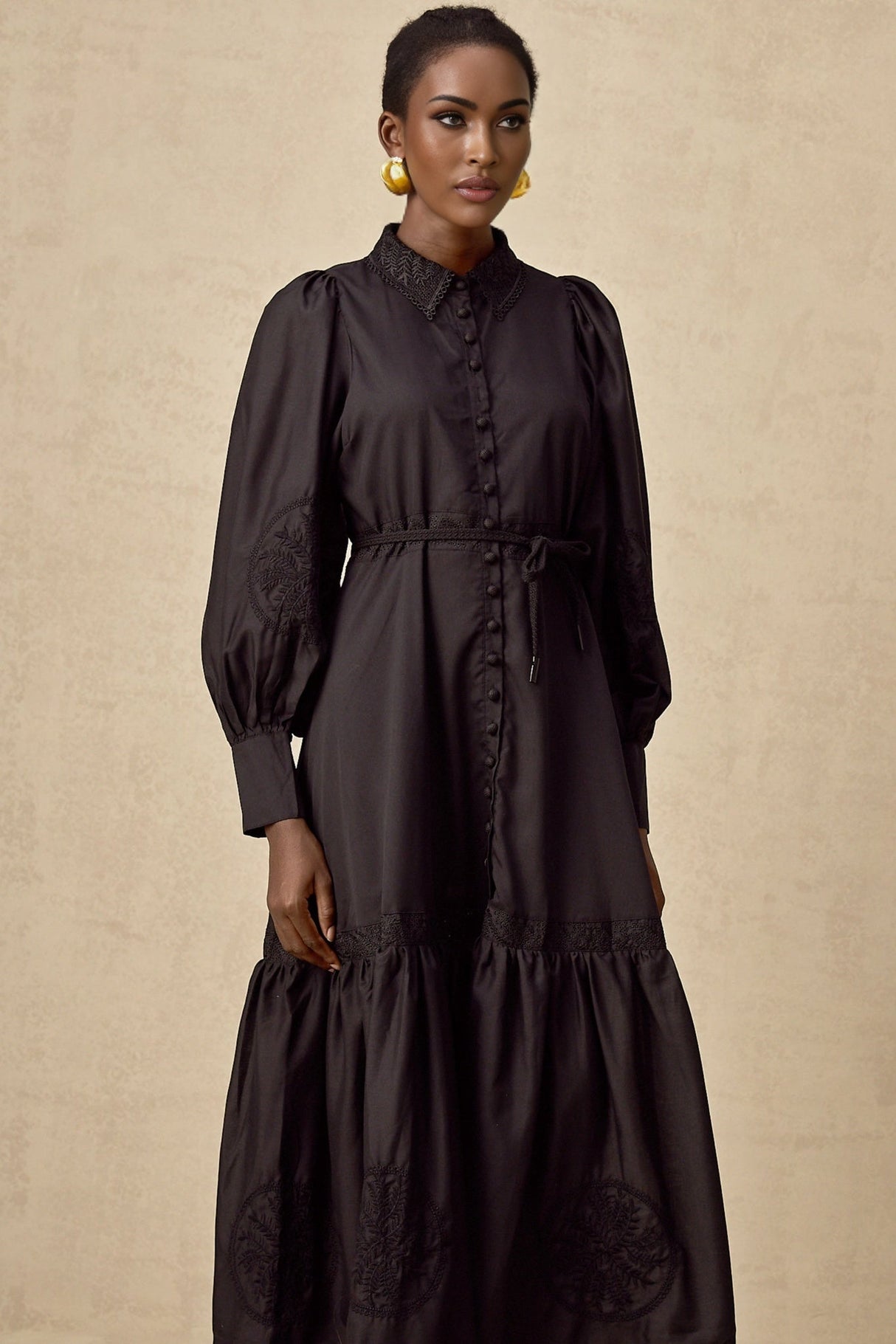 A black midi dress with lace embroidery details named Arcadia