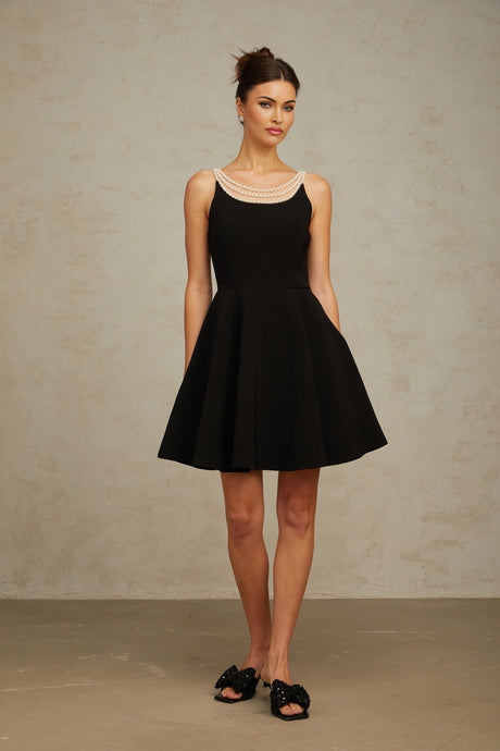 A black mini dress adorned with faux pearl embellishments named Danae