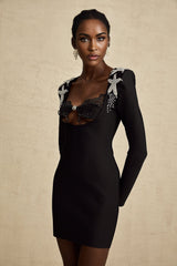 A black mini dress with a bustier top covered in shimmering sequins featuring thin straps and a fitted silhouette