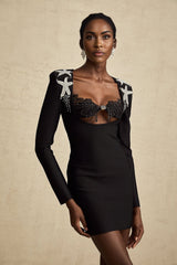 A black mini dress with a bustier top covered in shimmering sequins