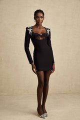 A black mini dress with a bustier top covered in shimmering sequins