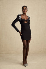 A black mini dress with a bustier top covered in shimmering sequins