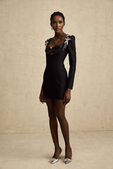 A black mini dress with a bustier top covered in shimmering sequins