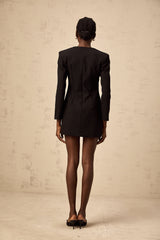 A black mini dress with a plunging V neckline adorned with crystal embellishments featuring a short hemline and fitted silhouette