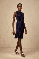 A black mini dress with a snake pattern design featuring a godet skirt silhouette