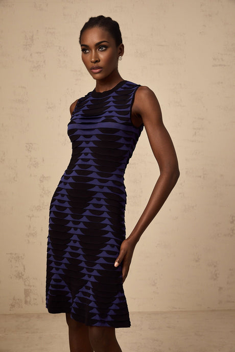 A black mini dress with a snake pattern design featuring godet inserts for added flare named Anais