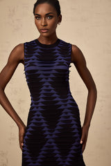 A black mini dress with a snake pattern design featuring godet inserts for added flare named Anais