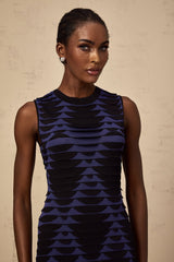 A black mini dress with a snakepattern design featuring a godet skirt and a fitted silhouette