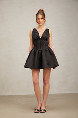 A black mini dress with a Vneck and flared skirt named Jeanne