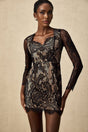A black mini dress with delicate floral embroidery and lace detailing featuring a feminine silhouette and intricate pattern throughout