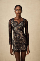 A black mini dress with delicate floral embroidery and lace detailing featuring a short hemline and feminine silhouette
