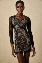 A black mini dress with delicate floral embroidery and lace detailing featuring a short hemline and feminine silhouette